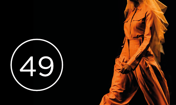 Fashion model on black background with number 49