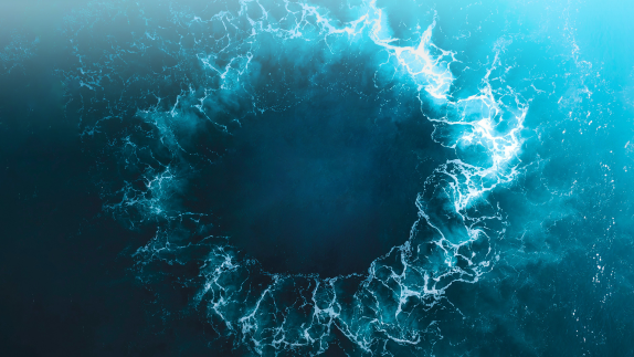 An image of a circular wave in the ocean.