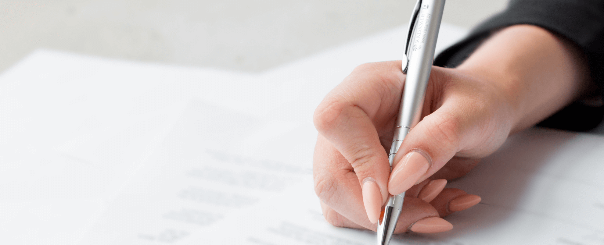 Woman signing a policy document
