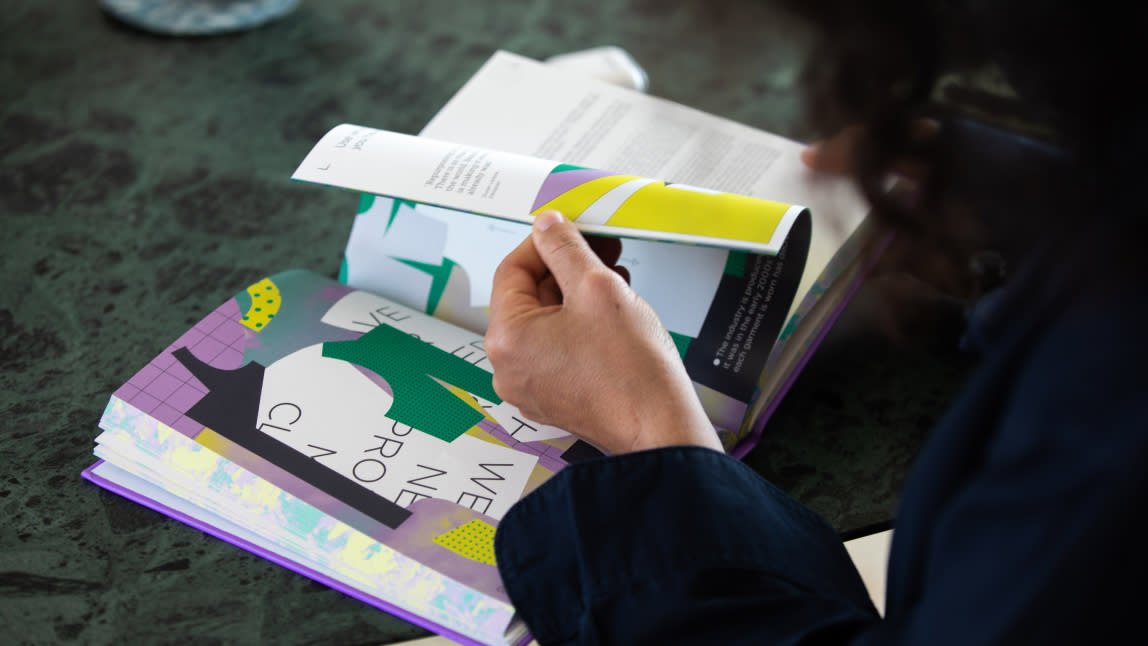 person reading the fashion book