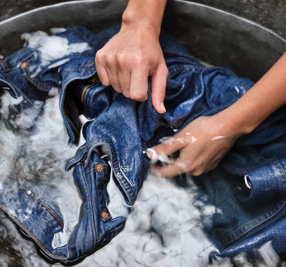 a person washing denim jeans