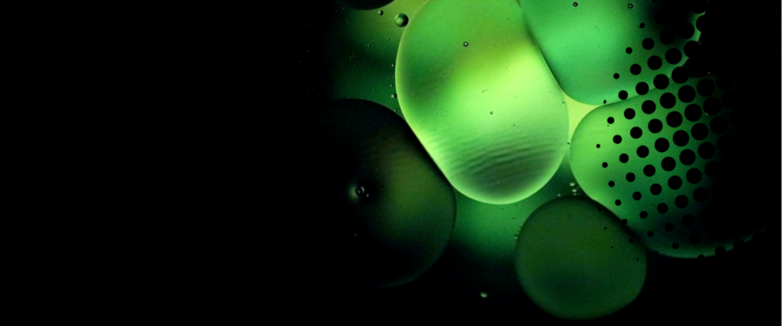 Abstract green water droplets on black background