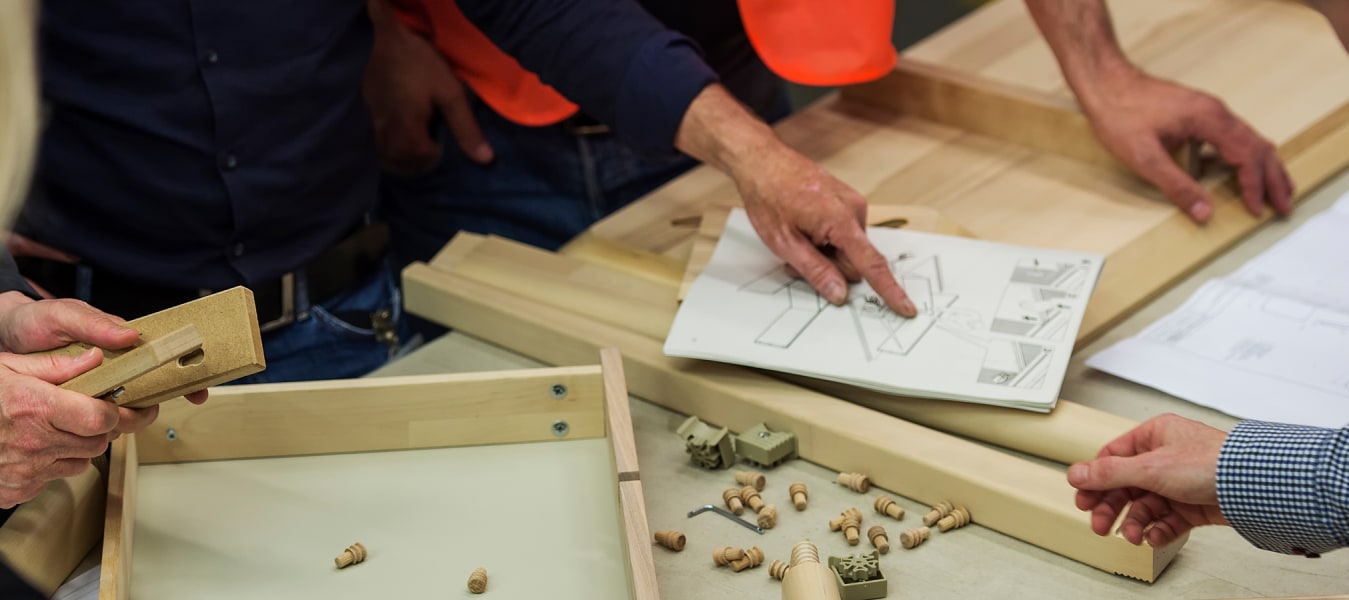 People pointing to diagram and building a product