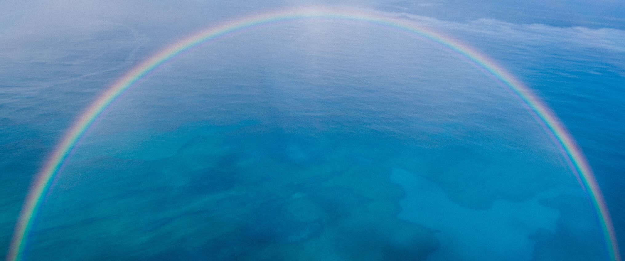 Image of rainbow above sea