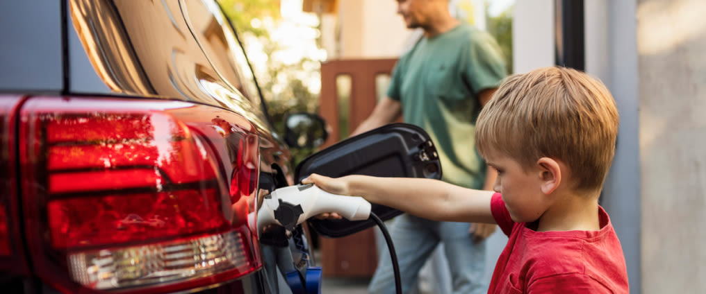 Child plugging in electric car