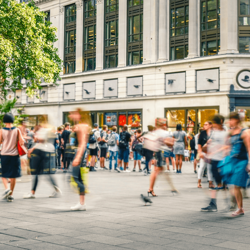 Pople walking around shopping in a busy city street