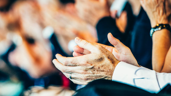 Generic image of an audience clapping