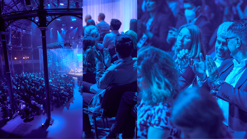Disrupted image of an event. With blue hues. A segment for of the venue and stage, with some crowd shots.