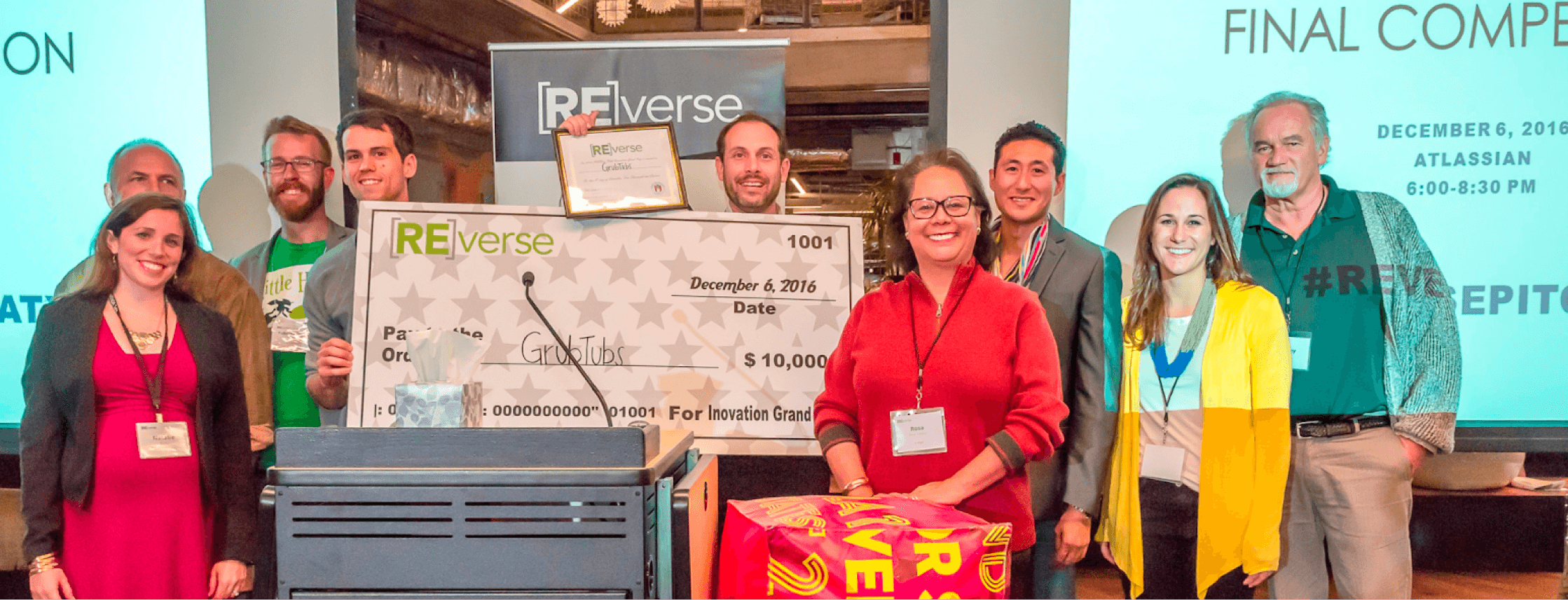 A group of people holding a cheque 