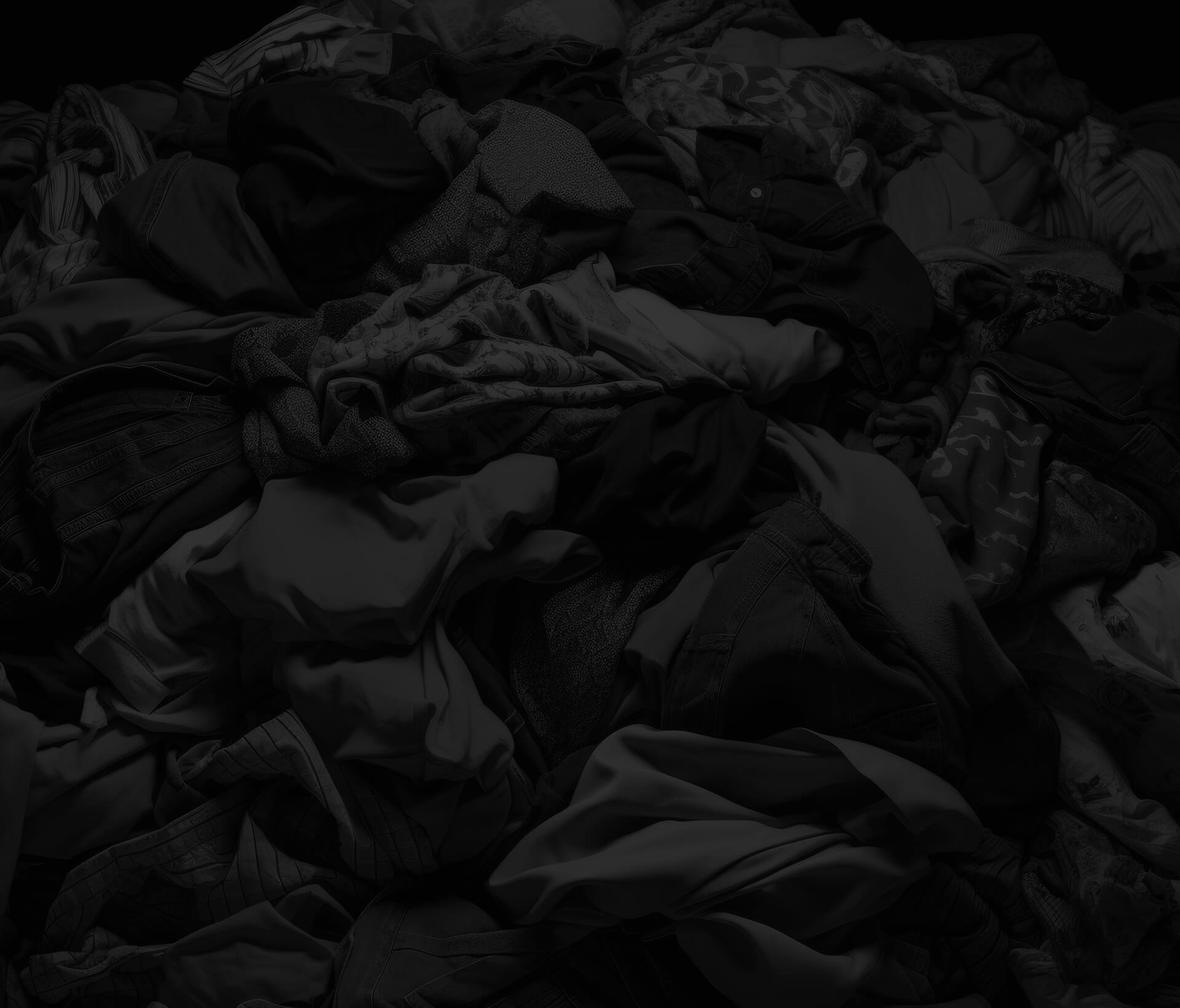 Clothes in a sorting heap on black background