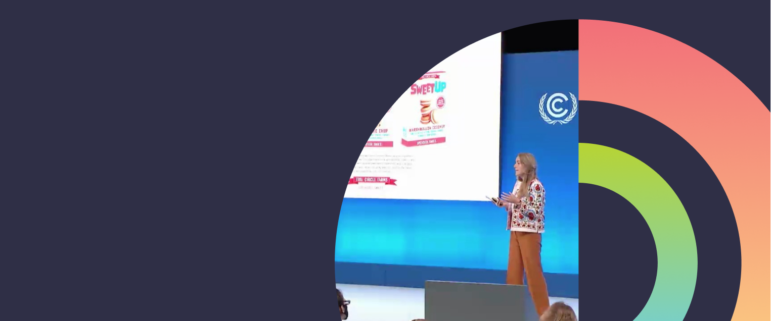 Person talking on stage with abstract circles