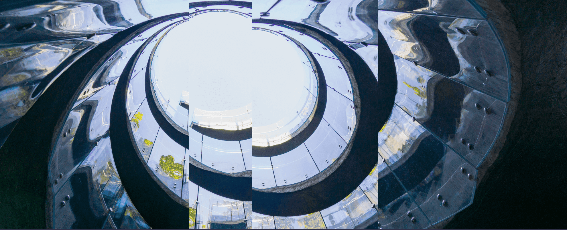 Circular building reflecting trees