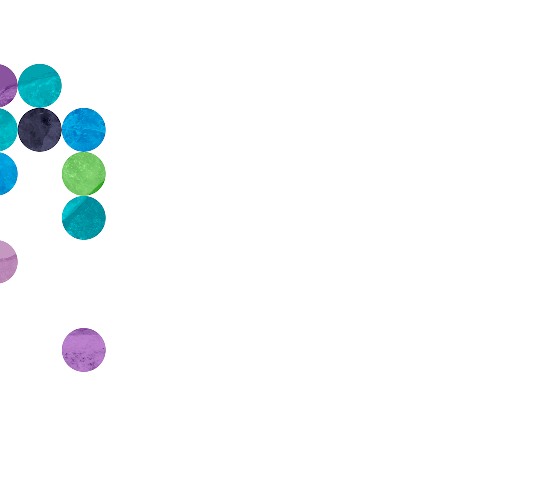 A cluster of textured, semi-transparent, colorful circles arranged in a loose vertical formation on the top left side of a white background. The circles are shades of teal, blue, purple, green, and black, with a few scattered lower down toward the center of the image.