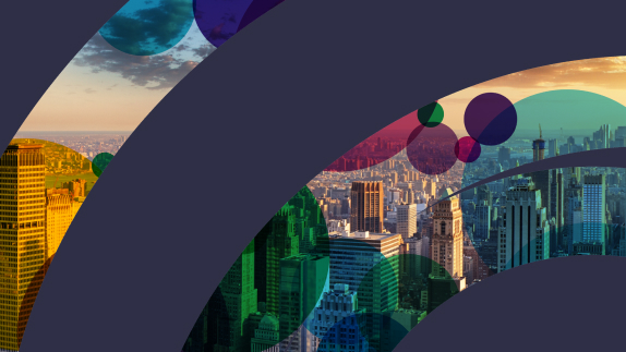 The cover image for the US Newsletter. It features a vast range of different buildings in an sunset setting. 