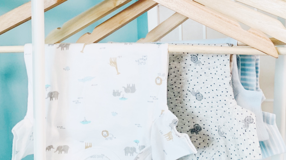 Baby clothing hung on hangers