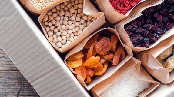 A photo looking down on some paper bags which has food in.