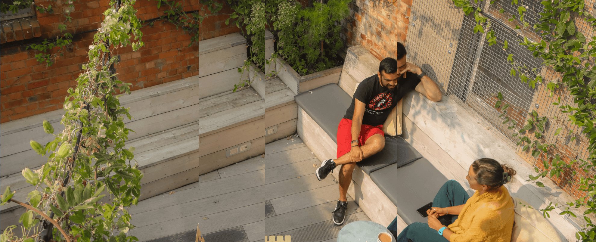 Two people sat in an office courtyard talking to one another