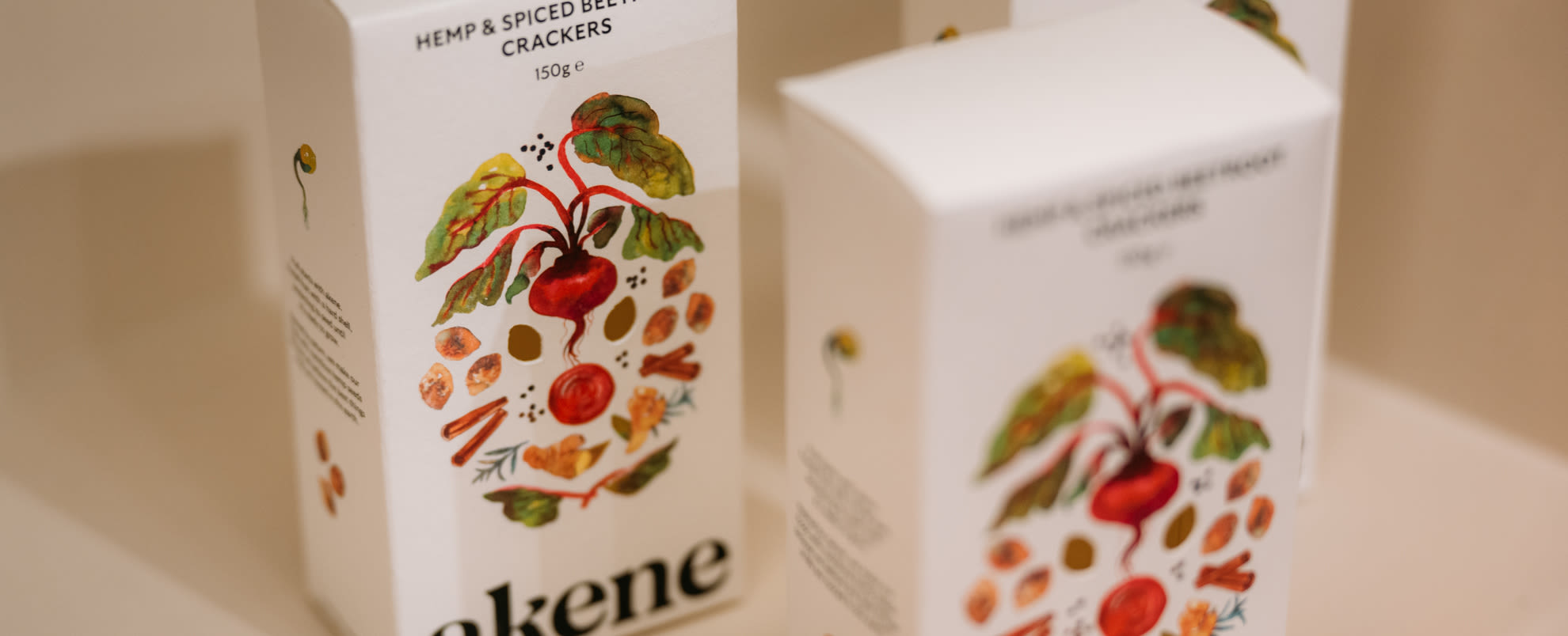 An image of three boxes of Akene crackers on a table.