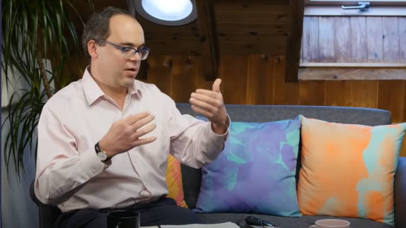 Person sat on sofa talking