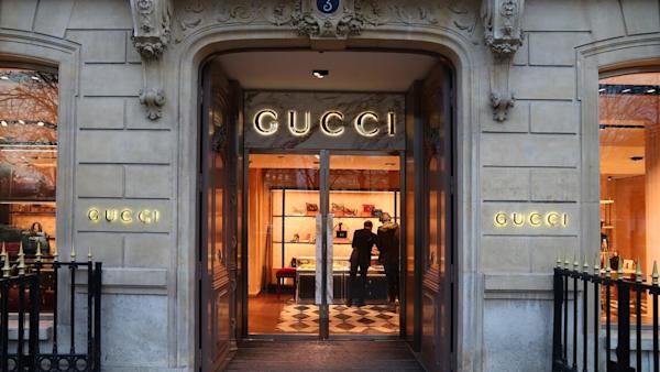 Image of the doors of a Gucci store with the Gucci sign.