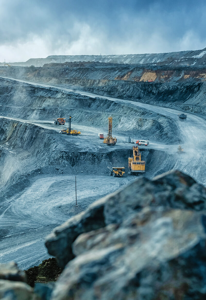 Mining pit with heavy machinery extracting minerals