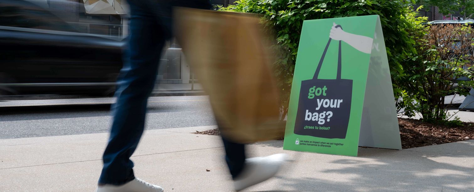 Person walking carrying a bag