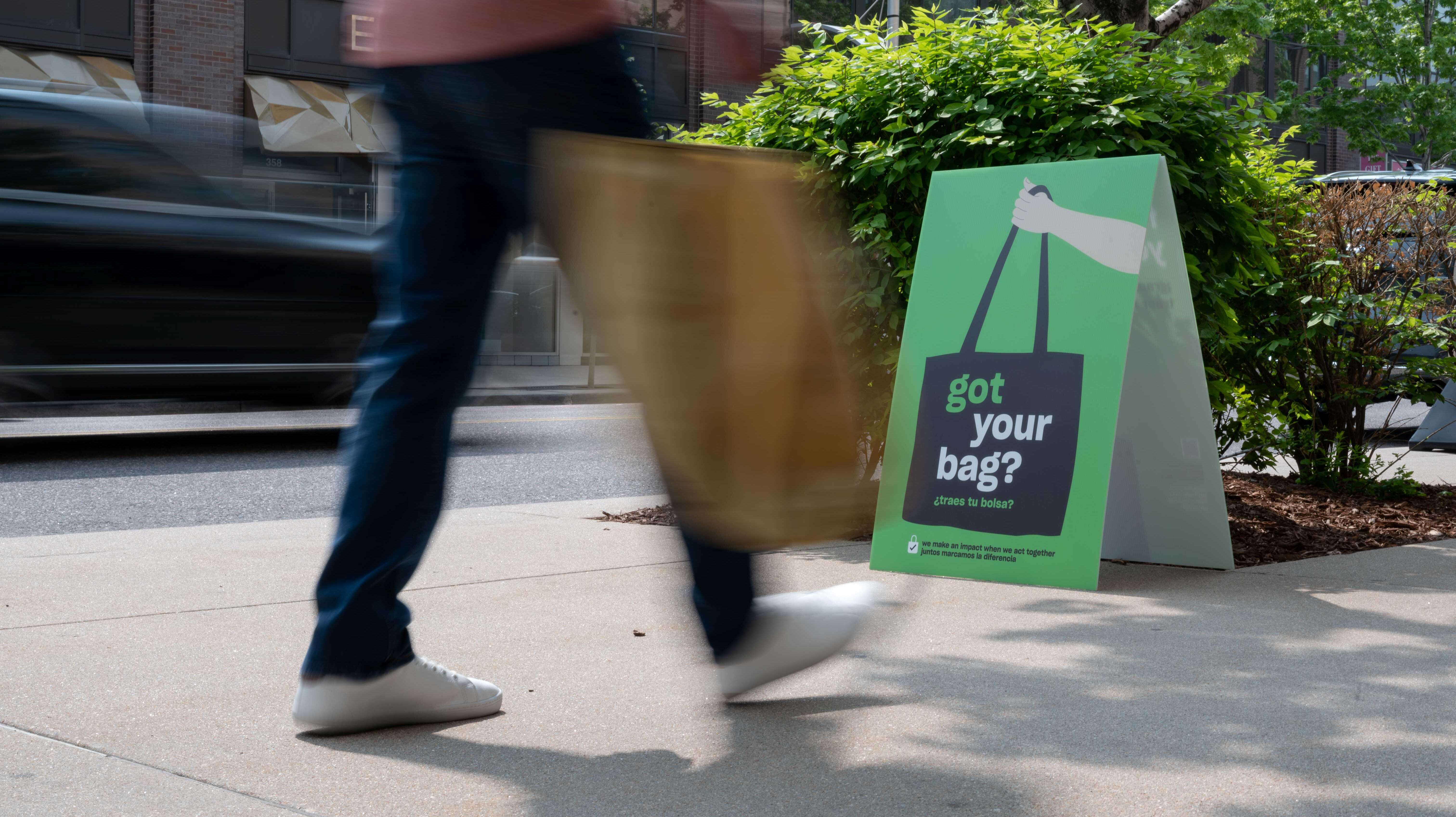 Person walking while carrying a bag
