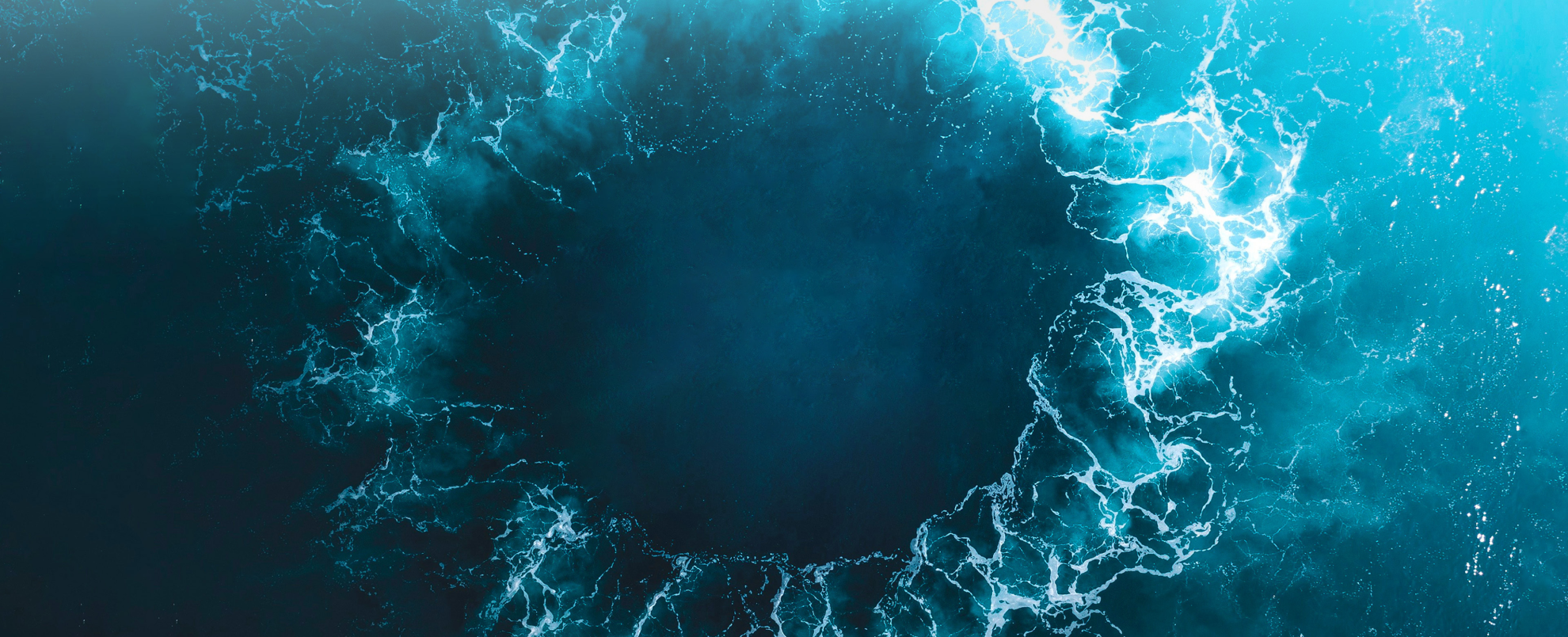 An image of a circular wave in the ocean.