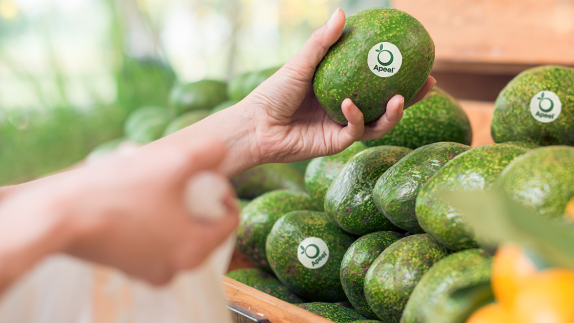 person selecting fruit from shelf