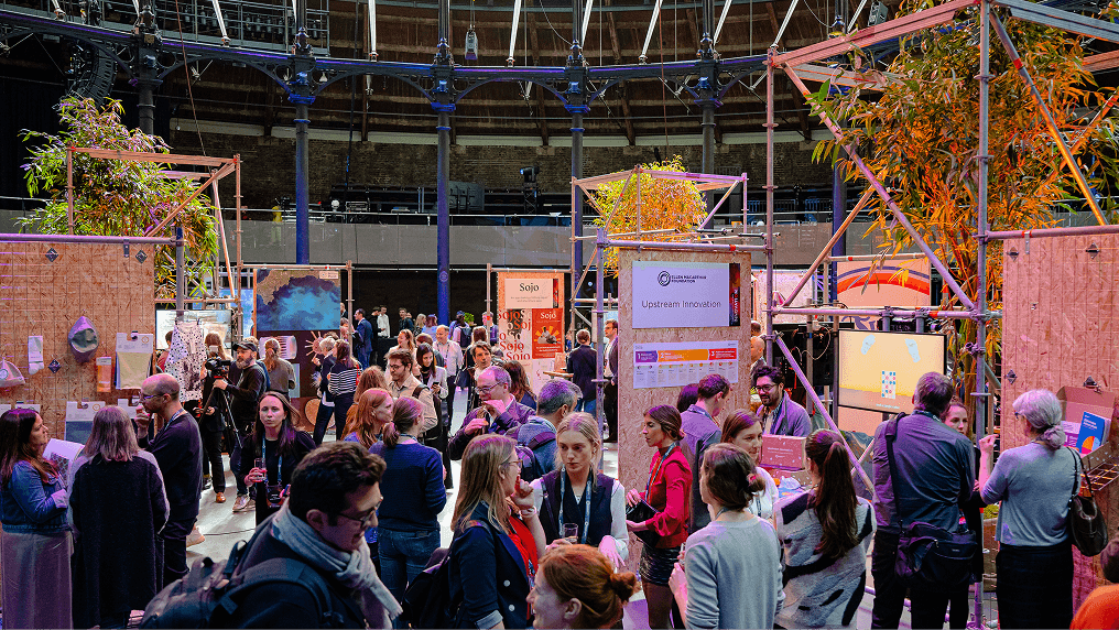 Network members walking around a circular economy exhibit