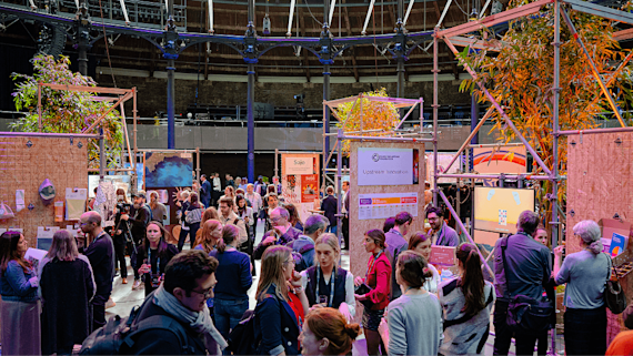 Network members walking around a circular economy exhibit
