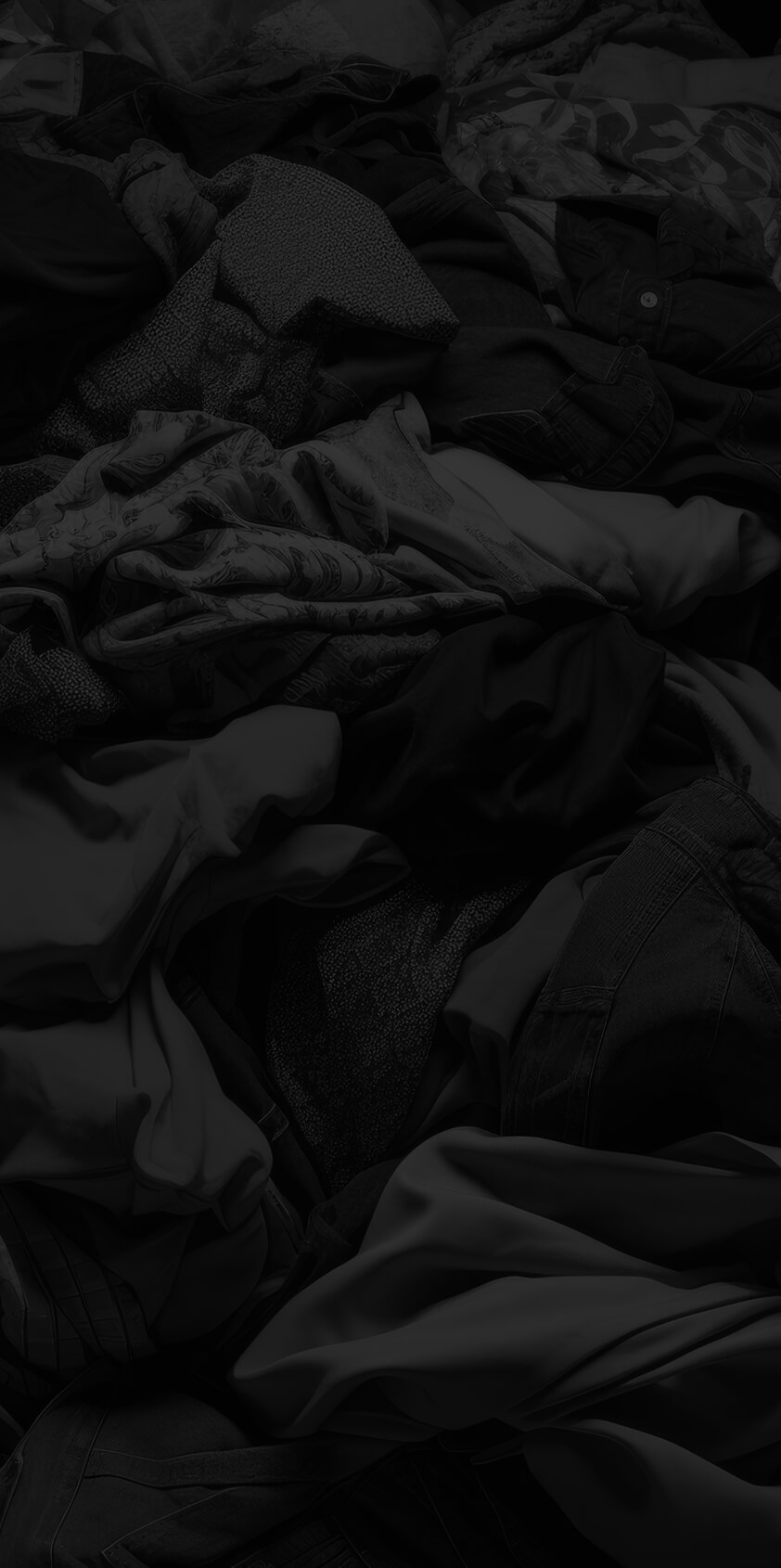 Clothes in a sorting heap on black background