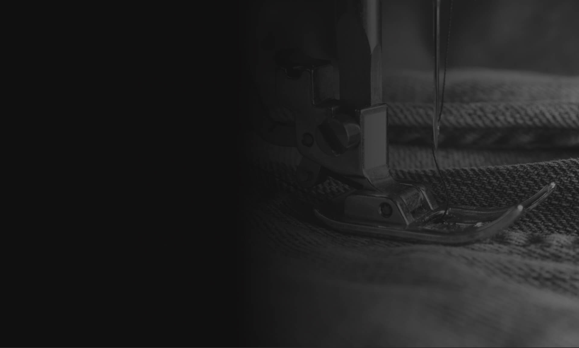 Black and white picture of someone sewing garments