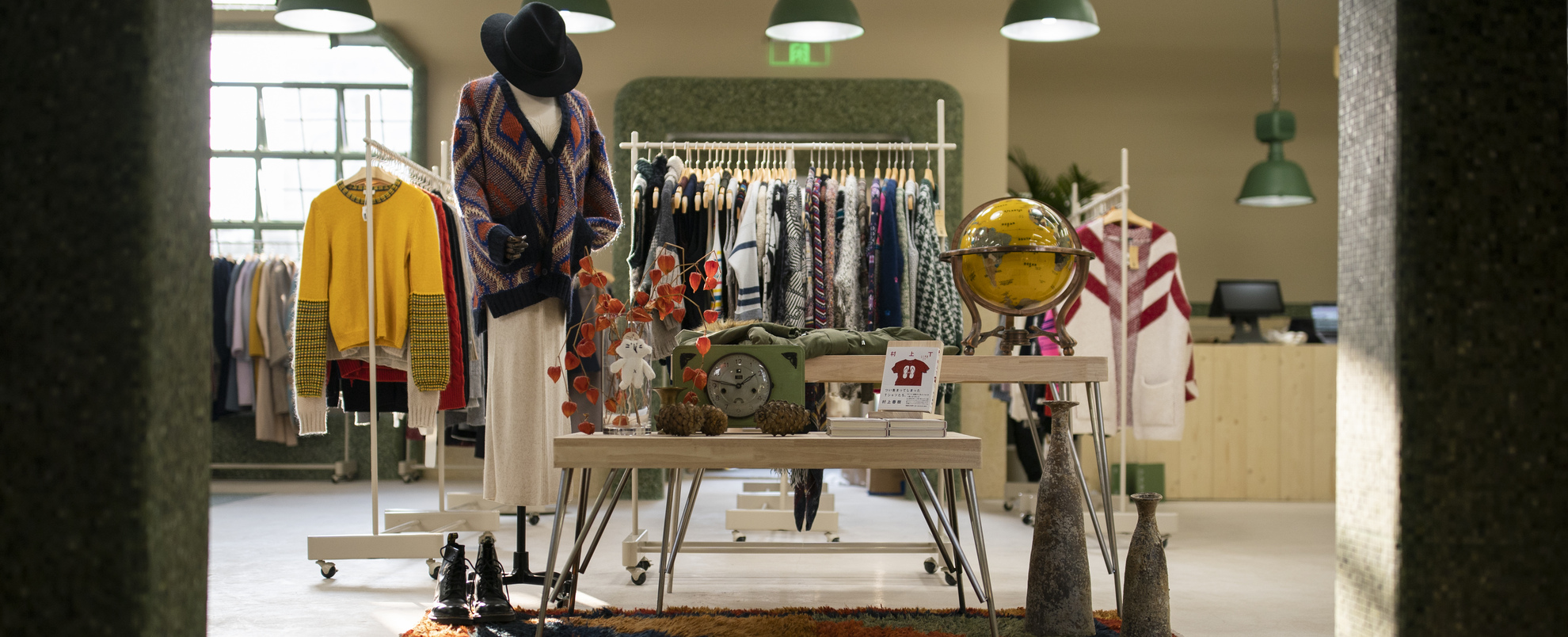 An image of some clothes and other items on a table in a shop. 