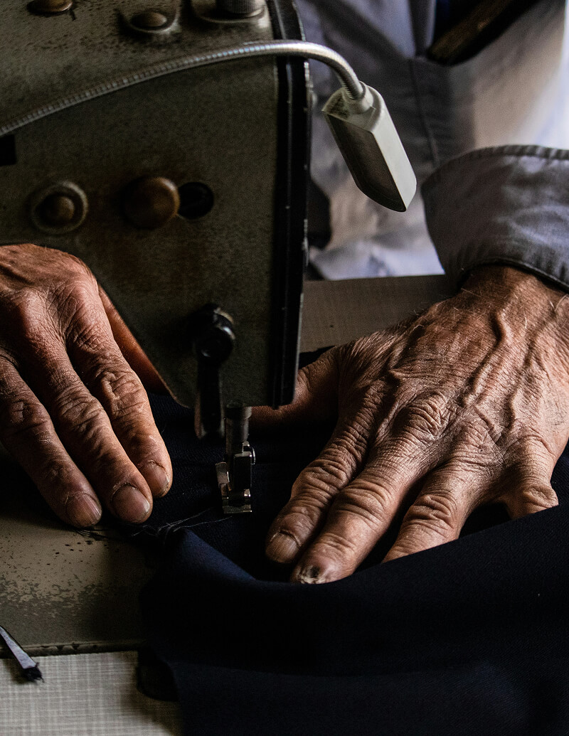 Person mending clothes on a sewing machine