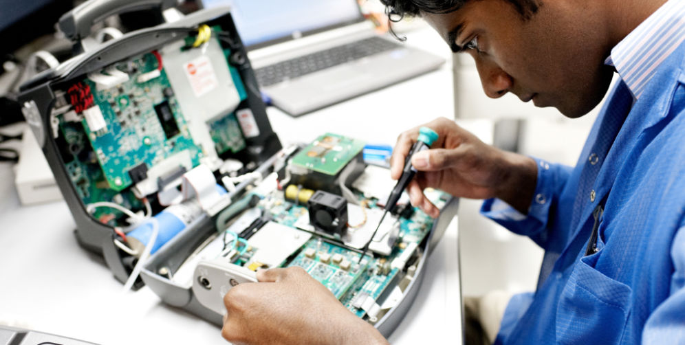 Man working on technology computer board