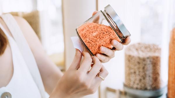 Person holding grains in jar