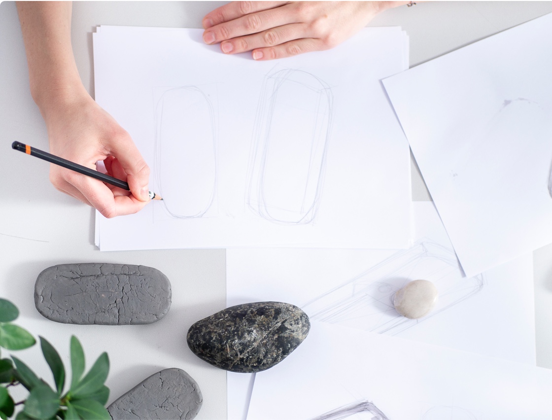 Images of Mudita Pure being sketched by an industrial designer, inspired by the shape of a stone.