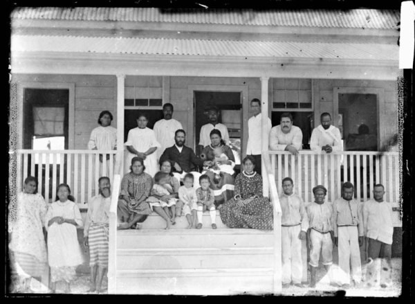 Photo is the property of the Trustees of the British Museum.  It pictures Eli Hutchinson Jennings Snr and his Samoan wife Malia Su'a sitting on chairs on top of the steps at their home in Olohega or Swains Island.