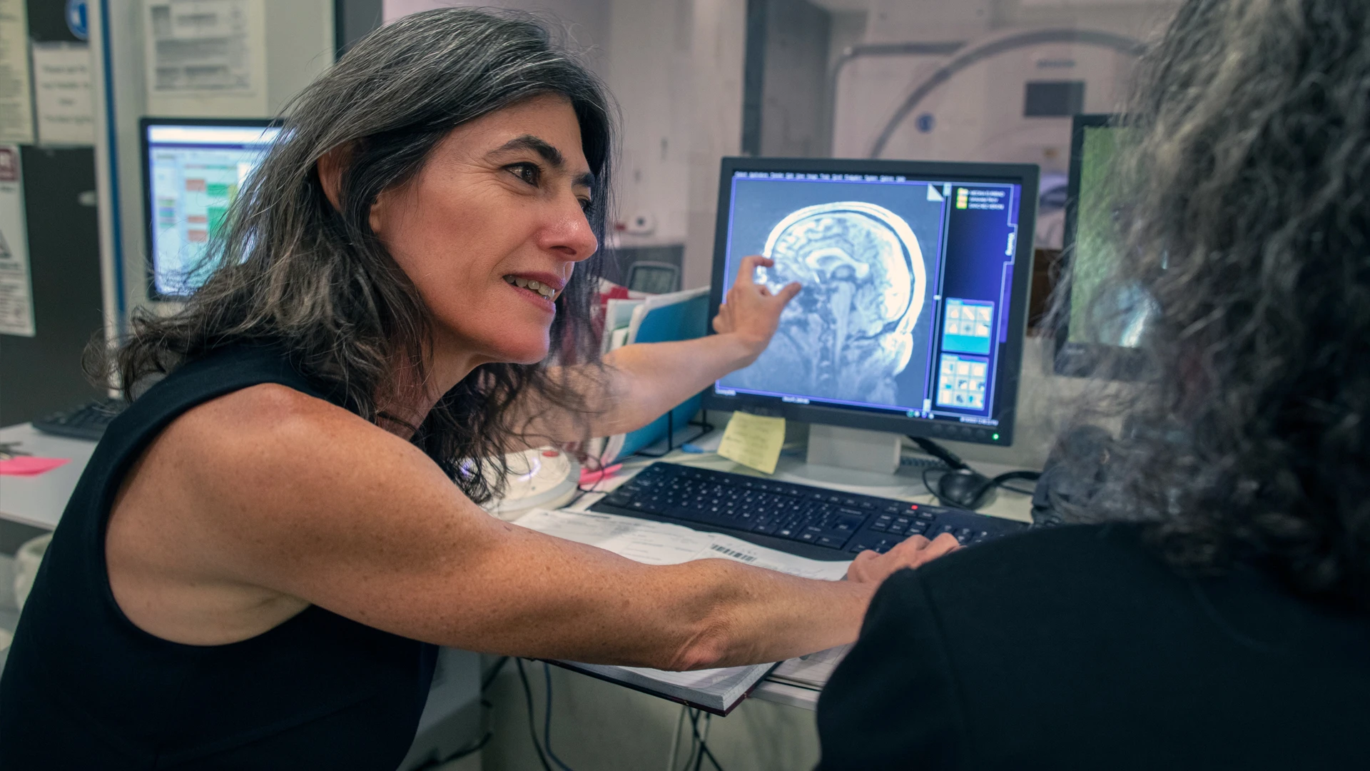 Dr. Goldstein examining a patient's brain MRI scan. Her team is pushing forward on a Phase 2 study that builds on initial findings regarding the direct brain stimulation of brain regions involved in cocaine and heroin addiction.