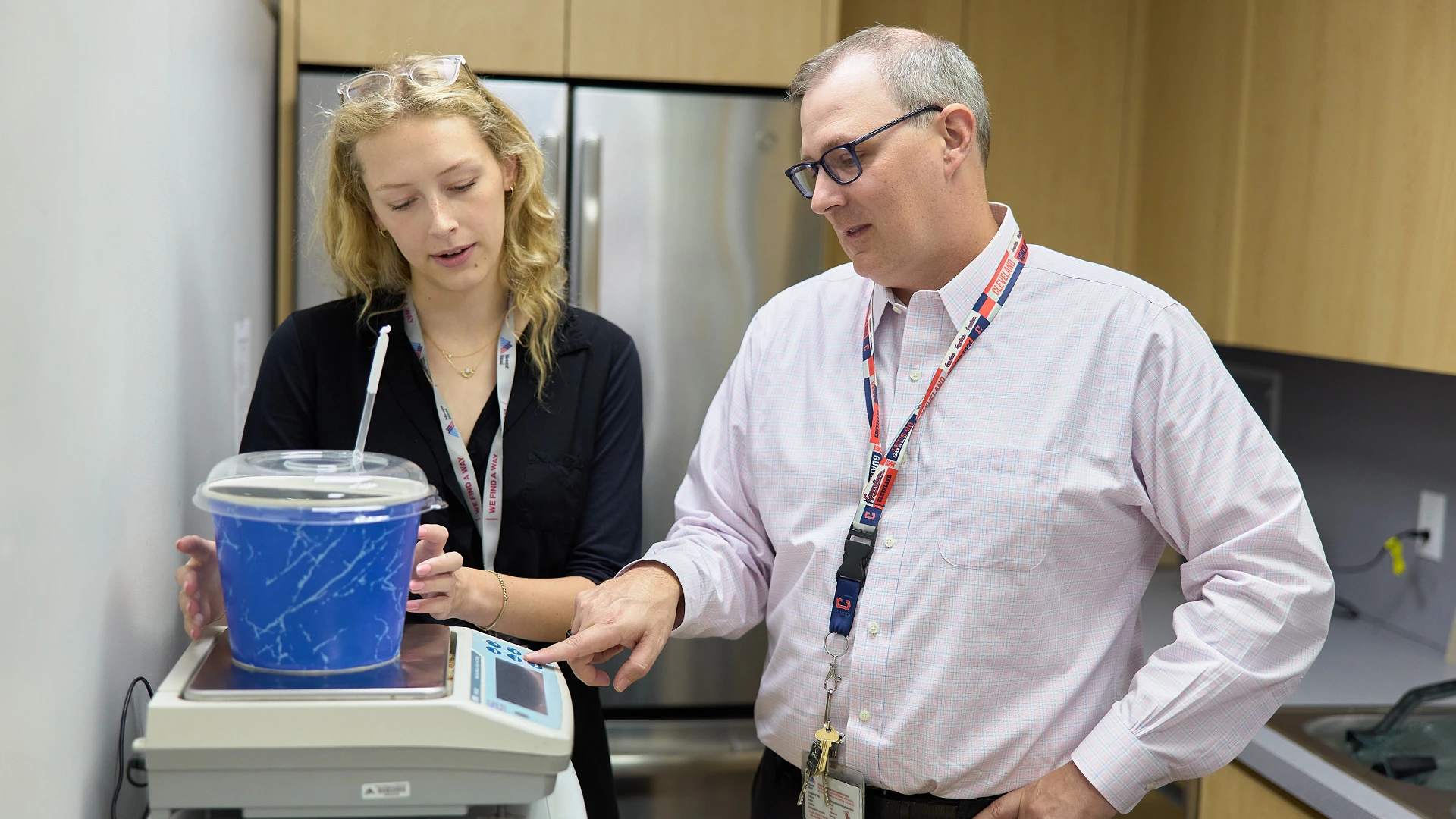 Food is medicine at the center, and a hallmark of treatment is the "mystery shake." Desiree Webb, lead research coordinator (left), and Dr. Hildebrandt (right), are preparing a container, which has a covered lid and an opaque covering to obscure the contents, to prevent patients from seeing what is contained within.
