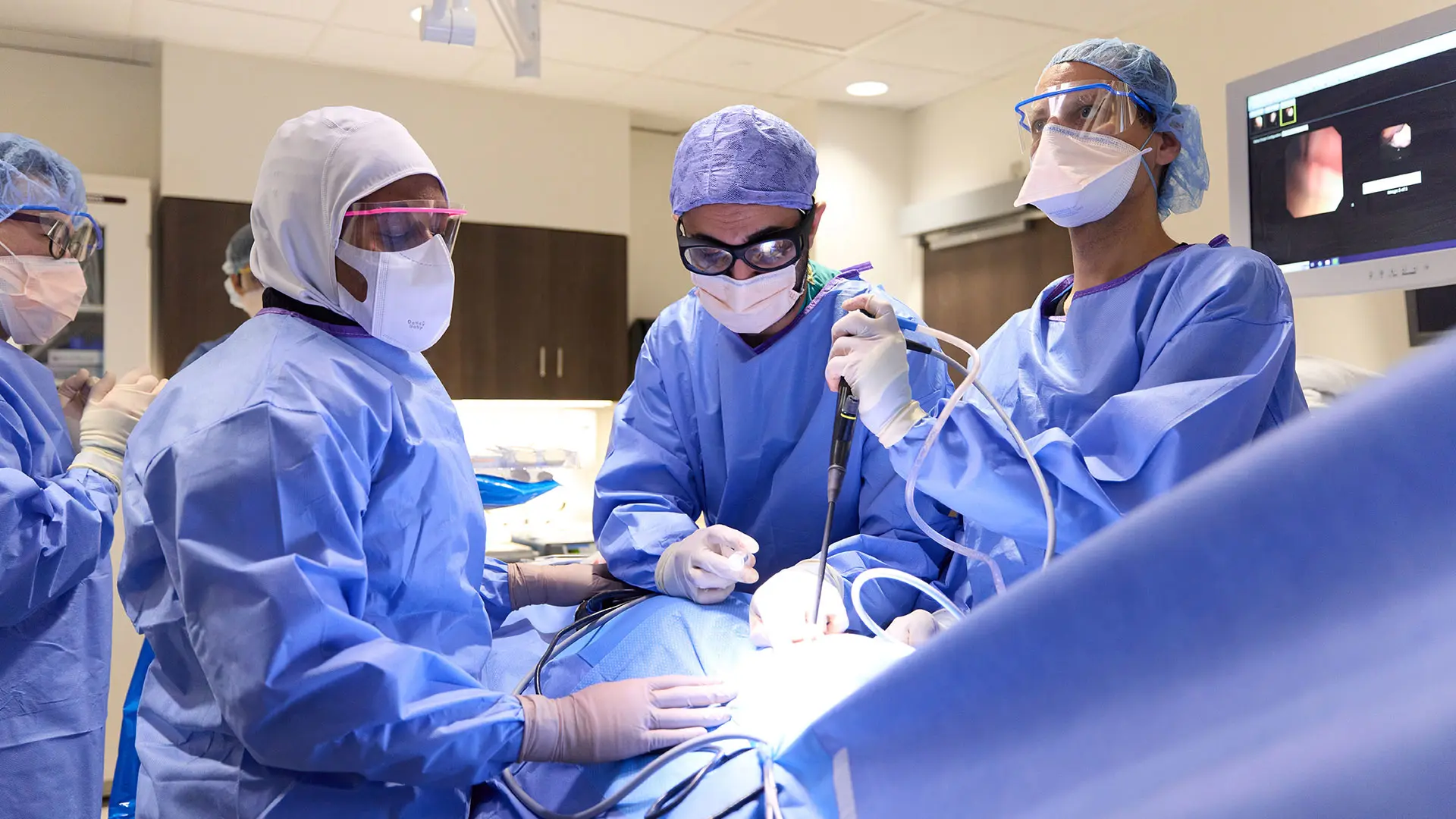 Udit S. Chaddha, MBBS (center), along with assistants Christian Lo Cascio, MD (Interventional Pulmonology fellow; right) and Idayat Brimah, MD (Pulmonary Critical Care fellow; left), and endoscopy technician Bongick Jang (far left), performing a pleuroscopy in the Mount Sinai West endoscopy suite. 