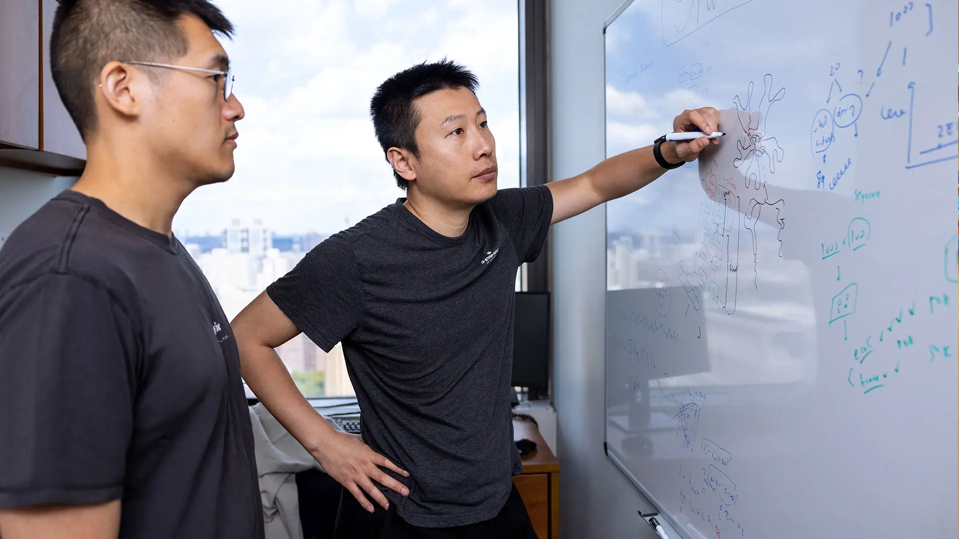 Yi Shi, PhD, right, brainstorming with Zhe Sang, a PhD candidate at Mount Sinai’s Graduate School of Biomedical Sciences, on his thesis project 