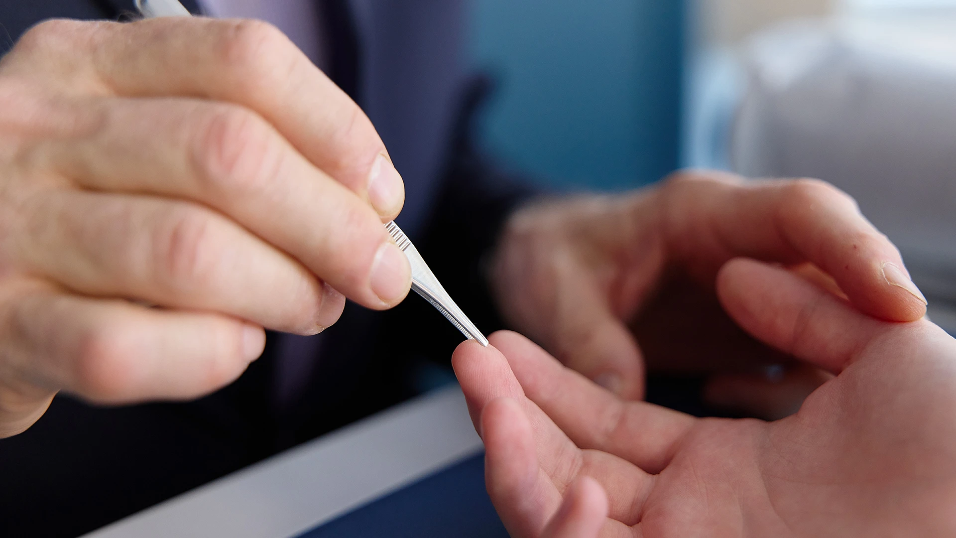 Dr. Hausman measures the patient’s nerve function by testing the sensitivity to being touched with one or two points of the testing instrument.