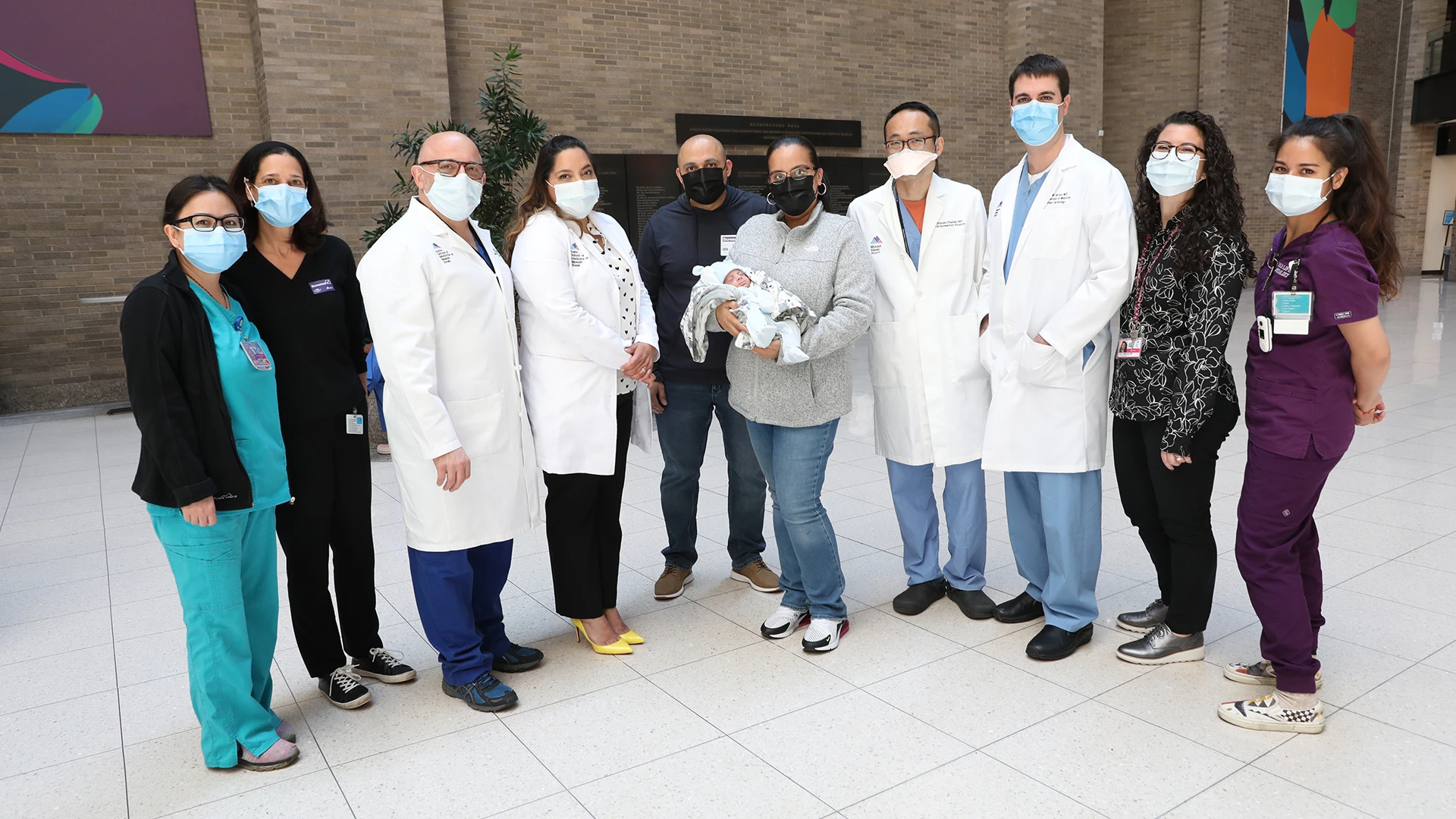 Yesenia, Martin, and Elias Lopez at The Mount Sinai Hospital in May 2021, surrounded by their team, from left: Jannette Valentin, RN; Jill Winston, LCSW; Francesco Callipari, MD; Sanam Ahmed, MD; Shinobu Itagaki, MD; Gregory Serrao; MD; Jenna Mennella, MD; and Claire Pettengill, Child Life Specialist.