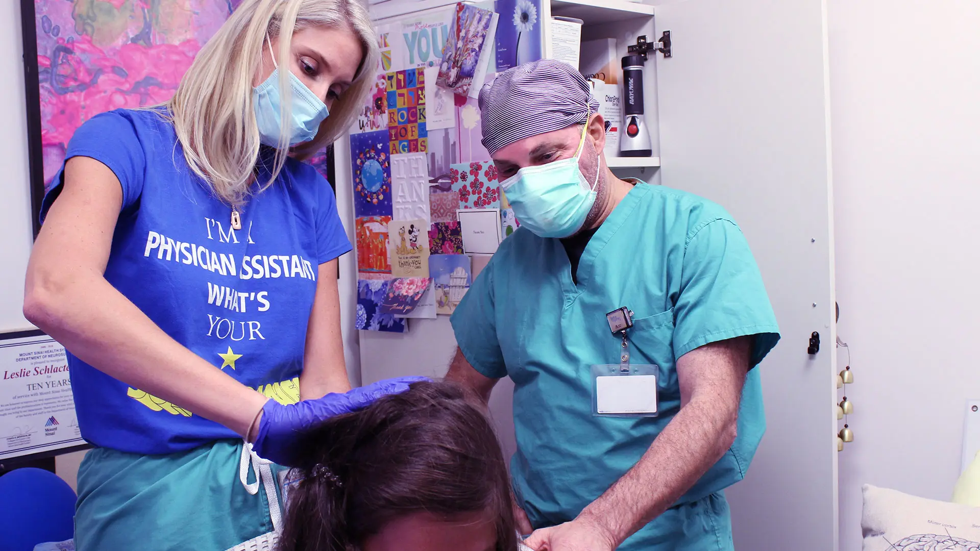 During the two-week postoperative visit, Joshua B. Bederson, MD, and Leslie Schlachter, PA-C, inspect Katelyn’s incision to ensure it is healing properly.




