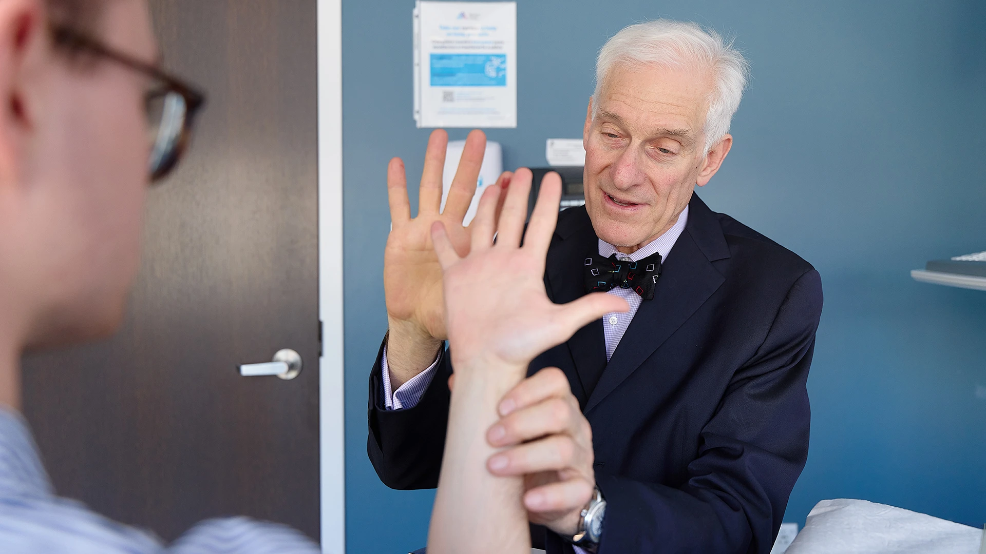 Dr. Hausman examines a patient’s finger range of motion after tendon reconstruction.