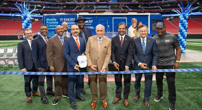 Pictured during launch ceremonies in Atlanta are, from left: Martin Sanda, MD, Milton Little, Herman ‘Skip’ Mason Jr., Kennard Hood, MD, (back row),  Ash Tewari, MBBS, MCh, FRCS (Hon.), Dsc (Hon.), Montell Jordan (behind Dr. Tewari), Arthur Blank, Suresh Ramalingam, MD, FACP, FASCO, Joon Lee, MD, and former Atlanta Falcons linebacker Chris Draft. Credit: Emory University
