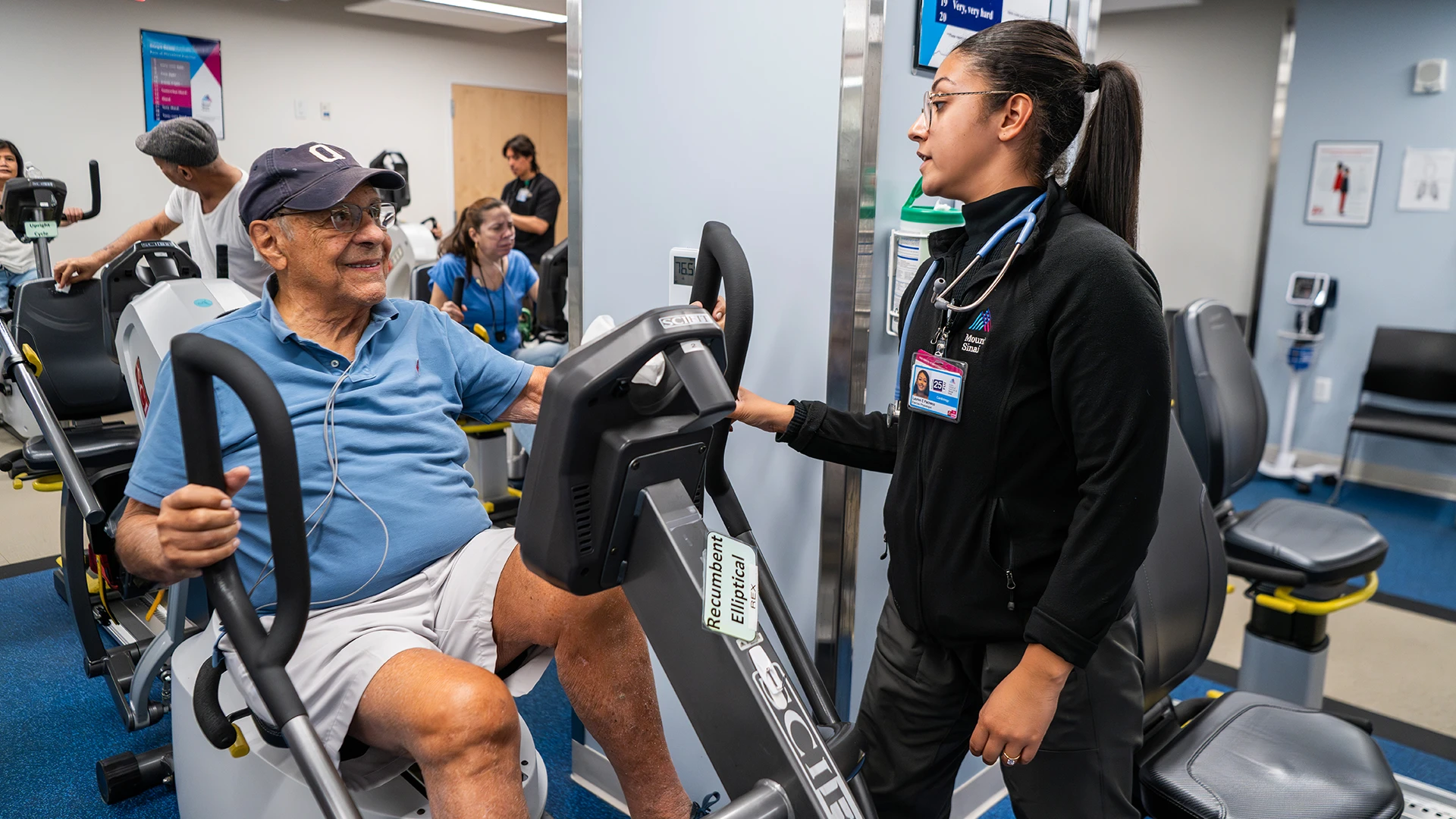  Exercise physiologist Lauren Pacheco helps a patient exercise in the rehab center