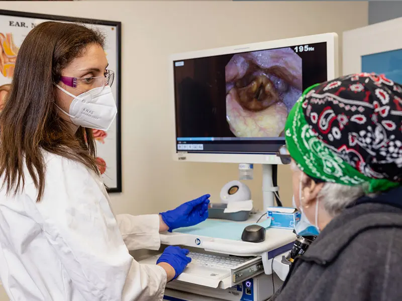 Dr. Kirke consults with a patient following stroboscopic and swallowing assessment. 



